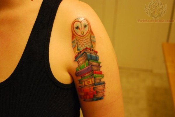 owl-sitting-on-stack-of-books-tattoo-on-bicep